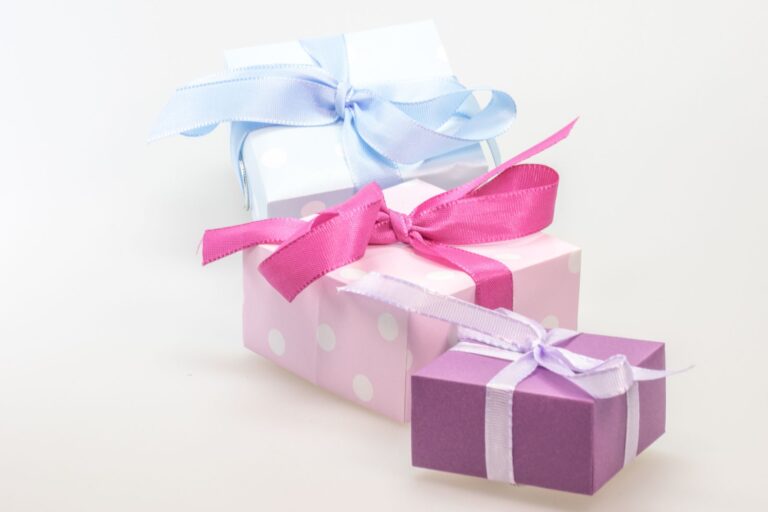 A trio of pastel gift boxes tied with vibrant ribbons, perfect for celebrations.