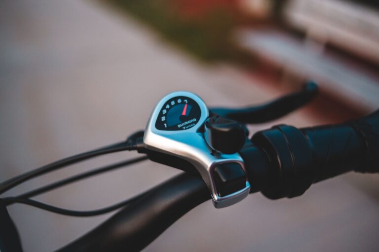 Close-up view of a modern bicycle gear shifter on a handlebar.