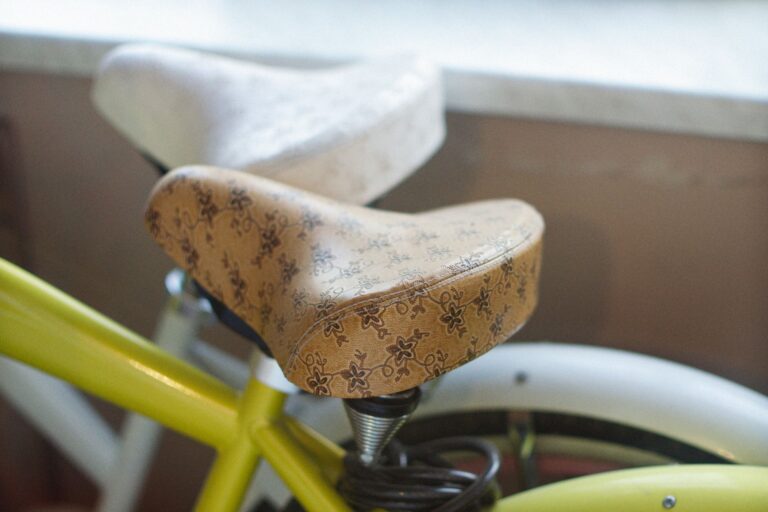 Detailed image of a patterned bicycle saddle showcasing intricate leather design indoors.