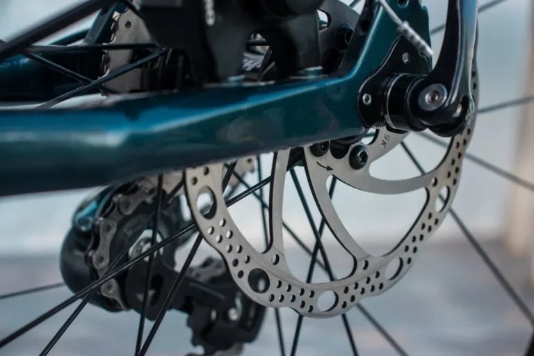 Detailed view of a bicycle brake rotor and caliper mechanism for cycling enthusiasts.