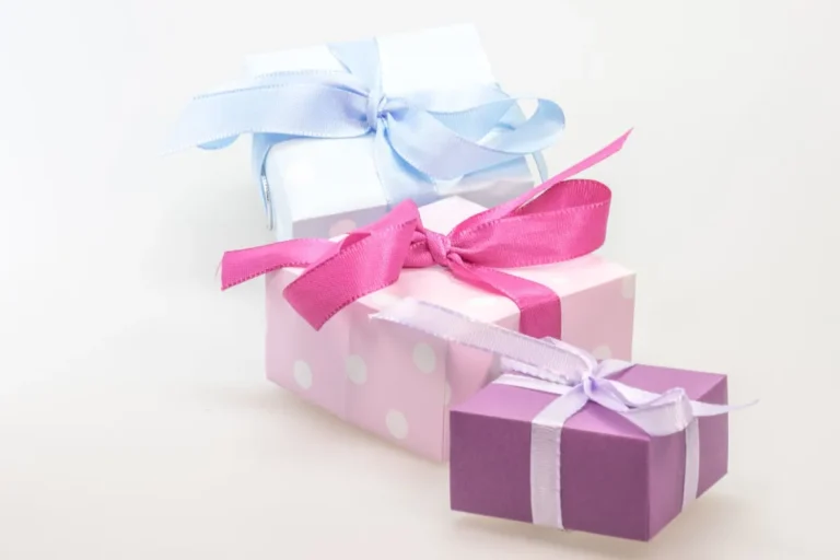 A trio of pastel gift boxes tied with vibrant ribbons, perfect for celebrations.