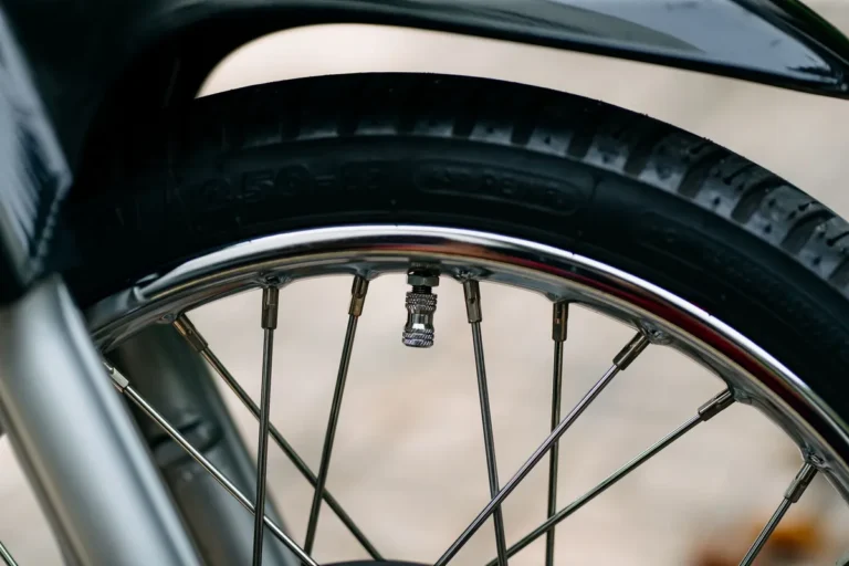 Detailed image of a bicycle wheel showcasing the tire treads and spokes in a close-up shot.